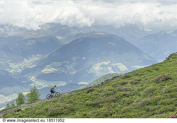 Mountain biker riding on uphill in alpine landscape  Trentino-Alto Adige  Italy
