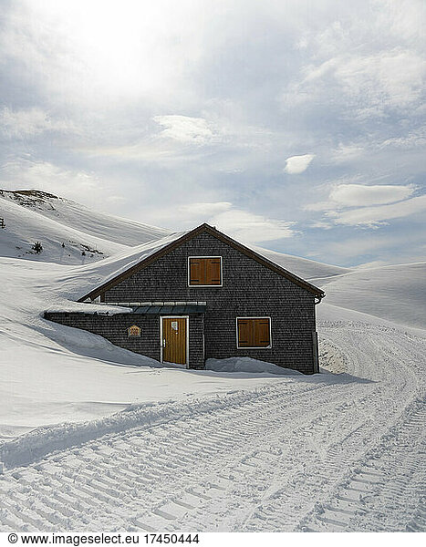 Mountain cabin covered with snow