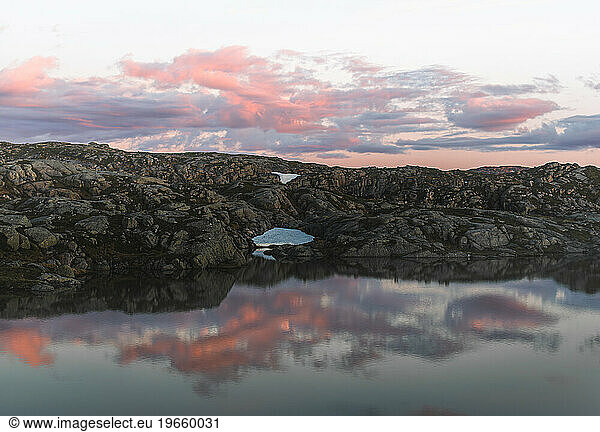 Mountain lake with reflection in the water at sunset  Norway