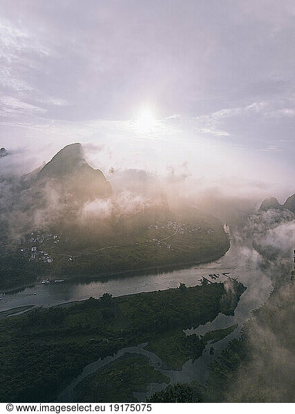 Mountain peak under cloudy sky at sunrise  Xingping Town  Guilin  China