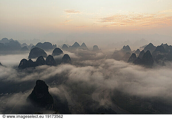 Mountain peaks with clouds at sunrise  Guilin  China