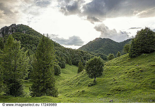Mountain ranges near valley by bright sky in Province of Brescia  Lombardy  Italy