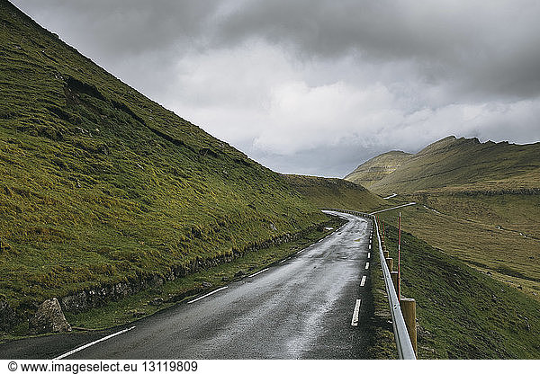 Mountain road against stormy clouds