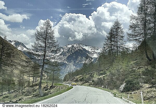 Mountain road near Passo di Valparola Valparola Pass in Alps  Porsche sports car in the background  Veneto  Italy  Europe