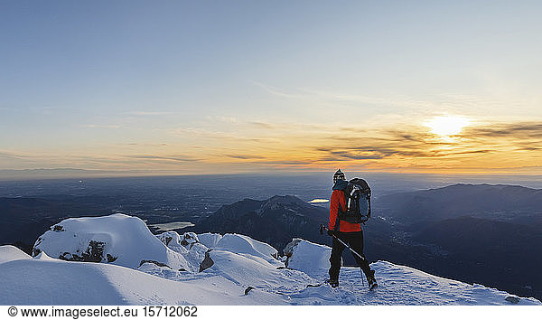 Mountaineer walking on top of a snowy mountain  Lecco  Italy