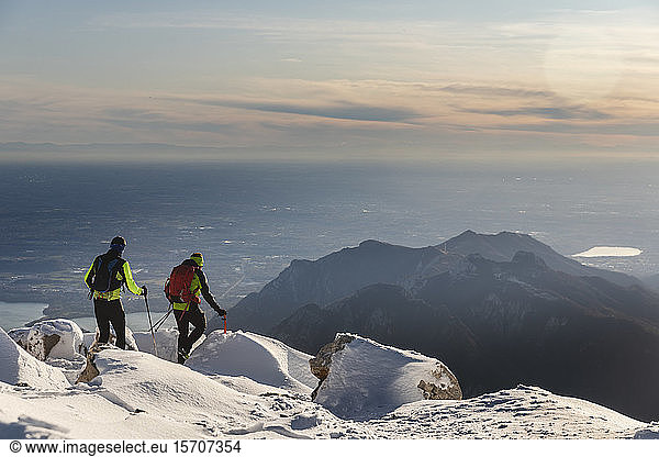 Mountaineers hiking on snowy mountain  Lecco  Italy