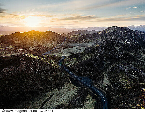 Mountainous area and highway at sunset