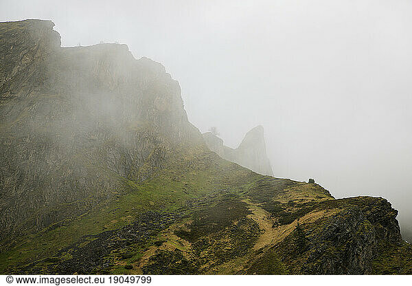 Mountainous landscape with fog in Lescun Valley  Pyrenees  France.