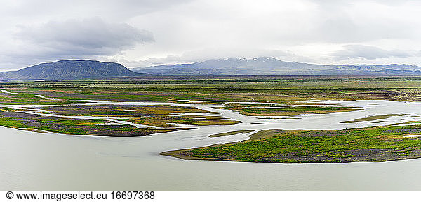 Muddy glacial melt rivers in Iceland's highlands on a soggy summer day