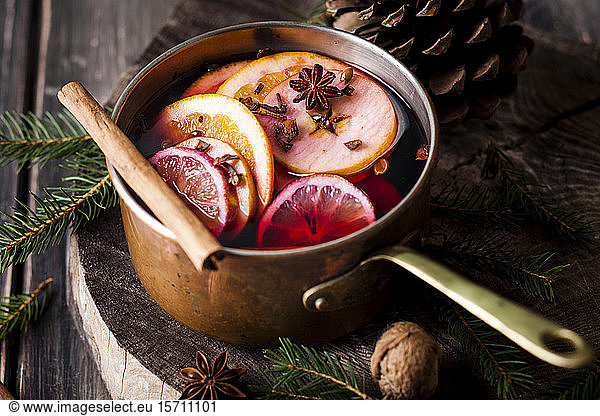 Mulled wine with oranges and cinnamon in a saucepan
