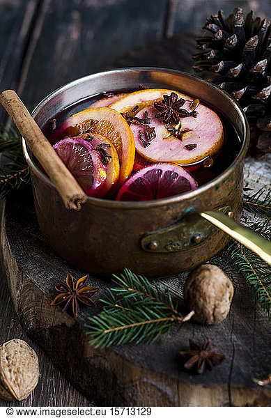 Mulled wine with oranges and cinnamon in a saucepan