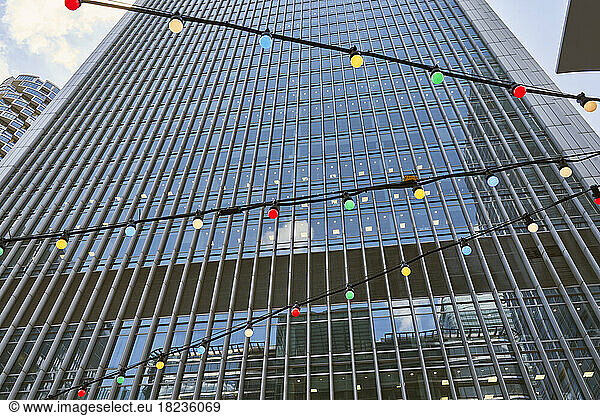 Multi colored light bulbs hanging in front of building