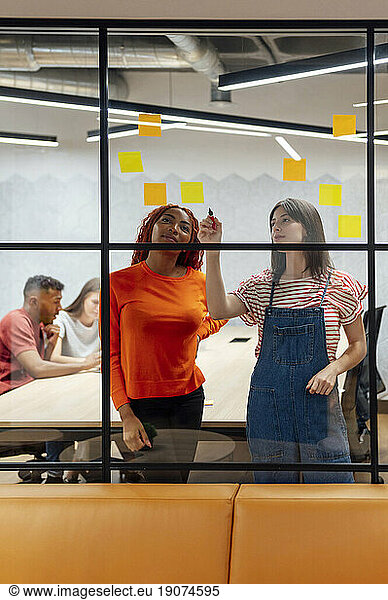 Multi-ethnic business colleagues planning together at office