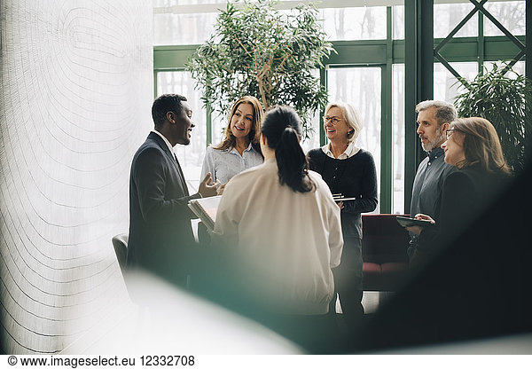 Multi-ethnic business people standing at office