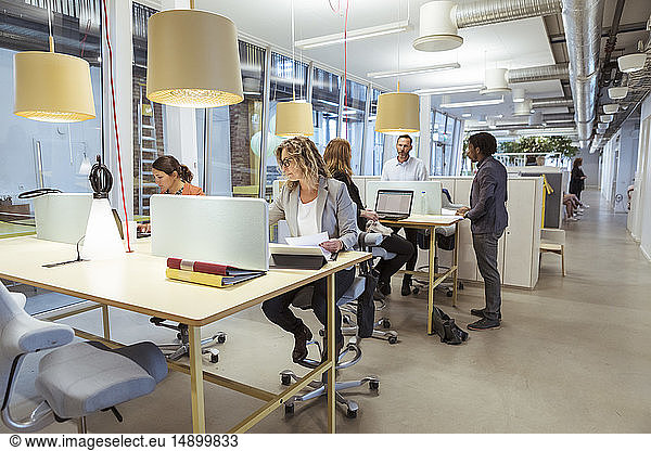 Multi-ethnic business people working at desk in office