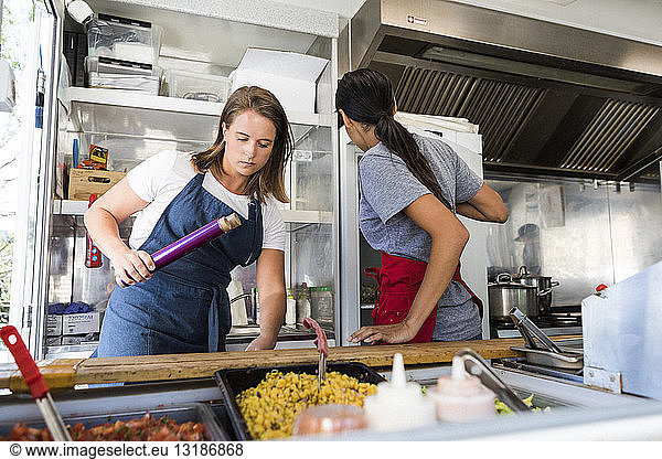 Multi-ethnic female colleagues working in food truck