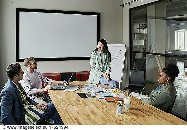 Multi-ethnic group of business colleagues sharing ideas in meeting at office