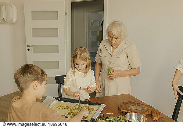 Multi-generation family preparing food at home