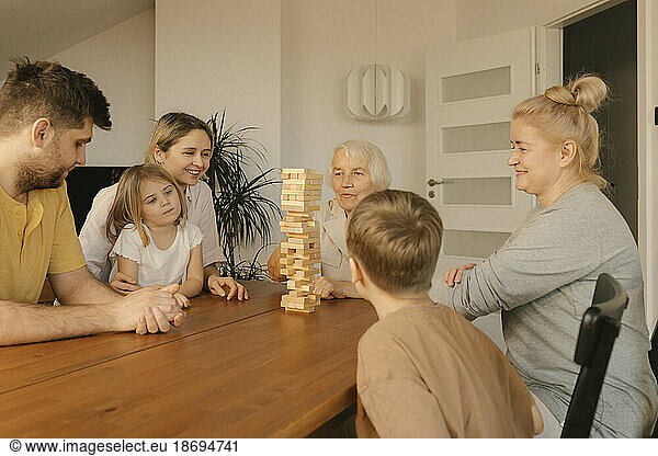 Multi-generation family spending leisure time playing game at home
