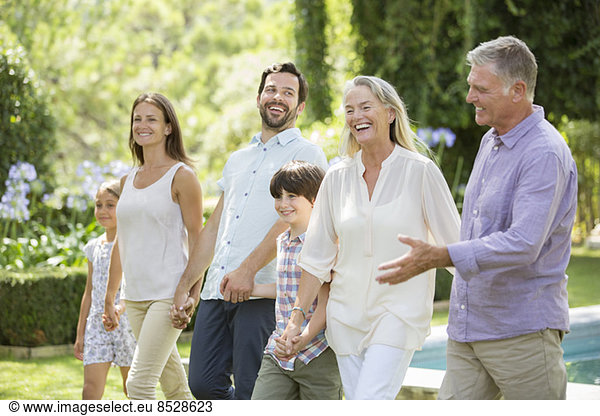Multi-generation family walking in backyard
