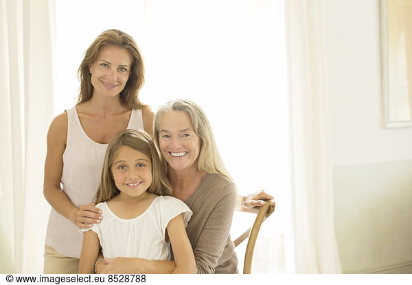 Multi-generation women smiling at window