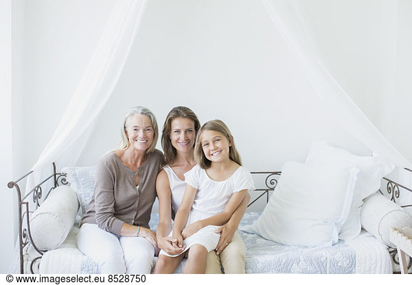 Multi-generation women smiling on daybed