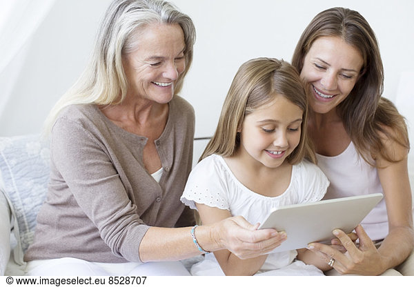 Multi-generation women using digital tablet