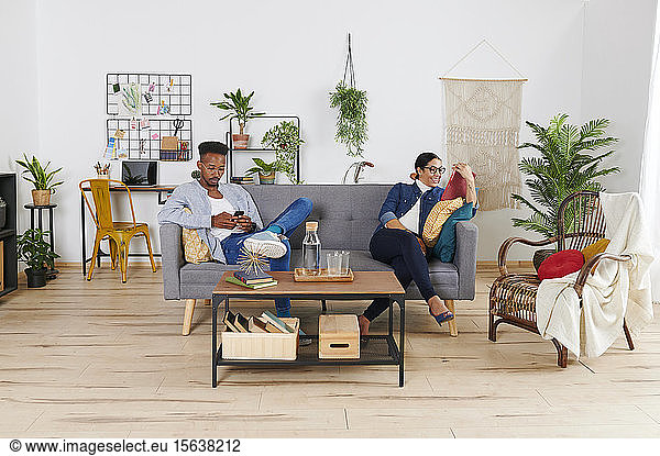 Multiethnisches Paar verbringt Zeit miteinander im Wohnzimmer