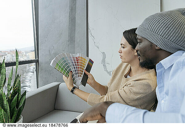 Multiracial designers choosing colors at office