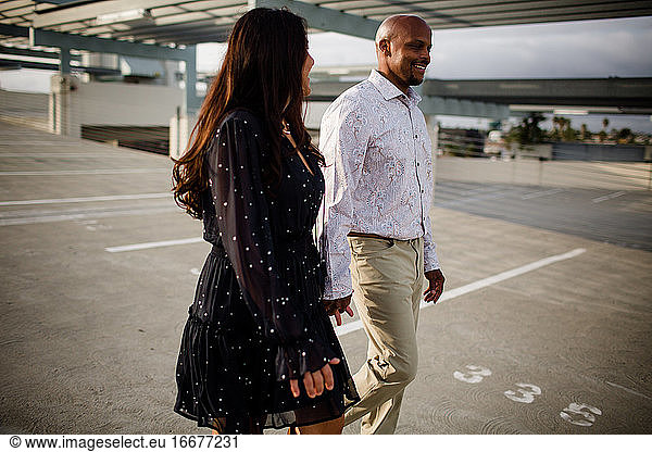 Multiracial Late Forties Couple Walking on Rooftop in San Diego
