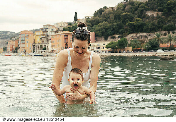 Mum and baby swimming in the Mediterranean Sea on the Côte d'Azur