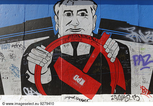 Mural  Gorbachev sitting behind the wheel with the communist hammer symbol  painting on a remaining piece est of the Berlin Wall  East Side Gallery  Berlin-Friedrichshain  Berlin  Germany