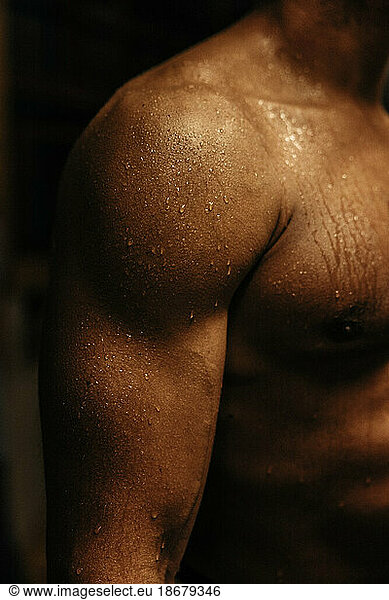 Muscular arm of male athlete with sweat
