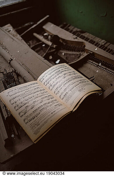 Music notebook on a broken piano