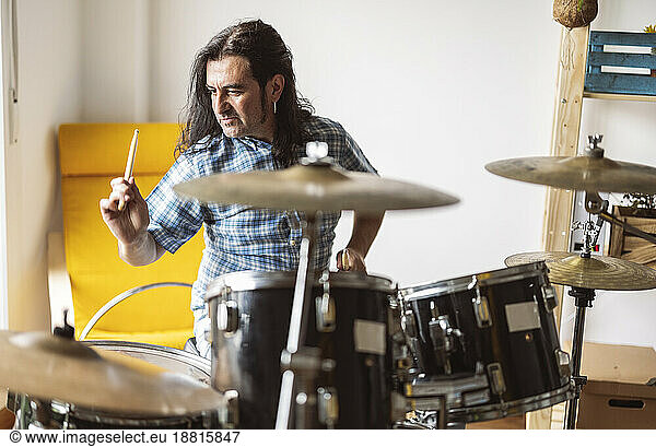 Musician playing drum at home