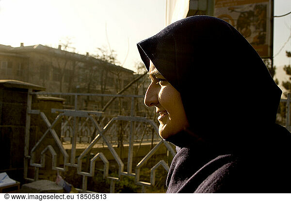 Muslim woman in a head scarf walks in Kabul