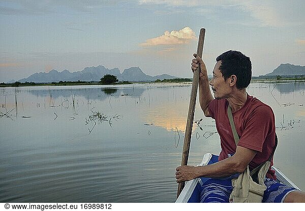 Myanmar  Kayin (Karen) State  Hpa-An  Boatman and flooded paddy fields near Saddar cave.