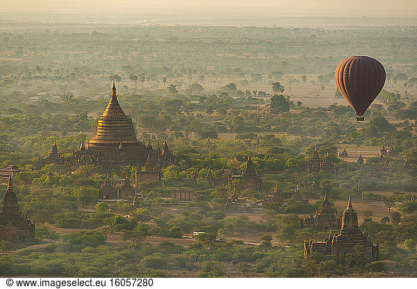 Myanmar  Mandalay Region  Bagan  Hot air balloon flying over Buddhist temples at dawn