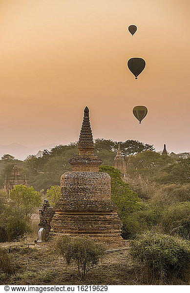 Myanmar  Mandalay Region  Bagan  Hot air balloons flying over ancient stupas at dawn