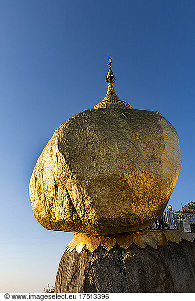 Myanmar  Mon state  Kyaiktiyo Pagoda  Golden rock against blue sky  low angle view