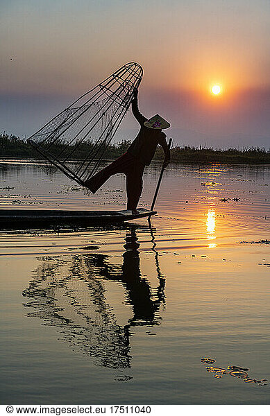 Myanmar  Shan state  Silhouette of traditional Intha fisherman on Inle lake at sunset