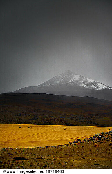 Mysterious snow capped mountain behind a desert in Bolivia
