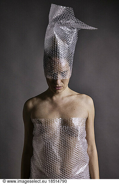 Naked woman wrapped in bubble plastic