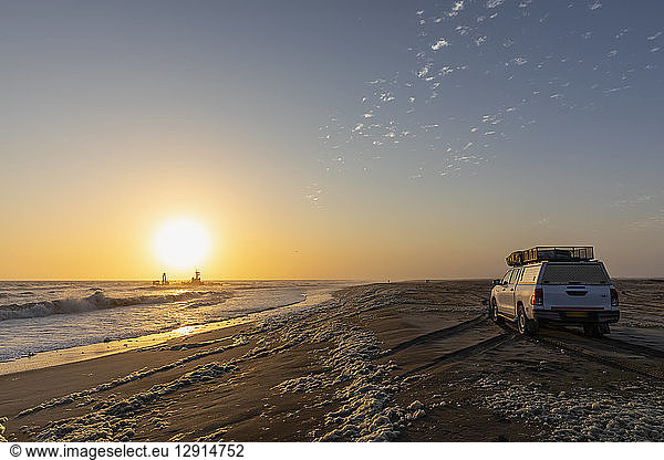 Namibia  Dorob National Park  Henties Bay  ship wreck of stranded Zeila  off-road vehicle at the beach
