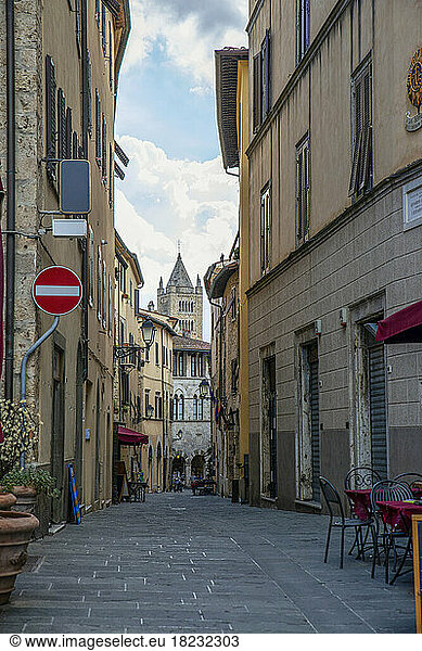 Narrow empty road amidst buildings at Massa Marittima  Tuscany  Italy