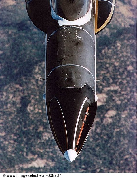 NASA´s F_18 from the Dryden Flight Research Center  Edwards  California  soars over the Mojave Desert while flying the third phase of the HARV High Alpha Research Vehicle program. This is a closer look at the set of control surfaces called strakes that were installed in the nose of the aircraft. The strakes  outlined in gold and white  are expected to provide improved yaw control at steep angles of attack. Normally folded flush  the units __ four feet long and six inches wide __ can be opened independently to interact with the nose vortices to produce large side forces for control. Testing involved evaluation of the strakes by themselves as well as combined with the aircraft´s Thrust Vectoring System. The strakes were designed by NASA´s Langley Research Center  then installed and flight tested at Dryden.