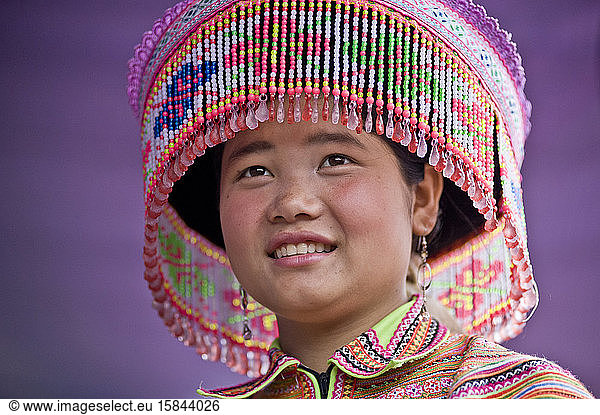 Native young Hmong lady wearing traditional colorful clothes