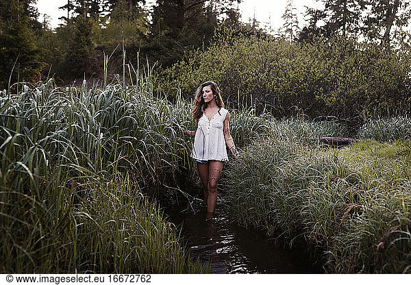 Natural beauty with tattoos in a meadow in Ucluelet