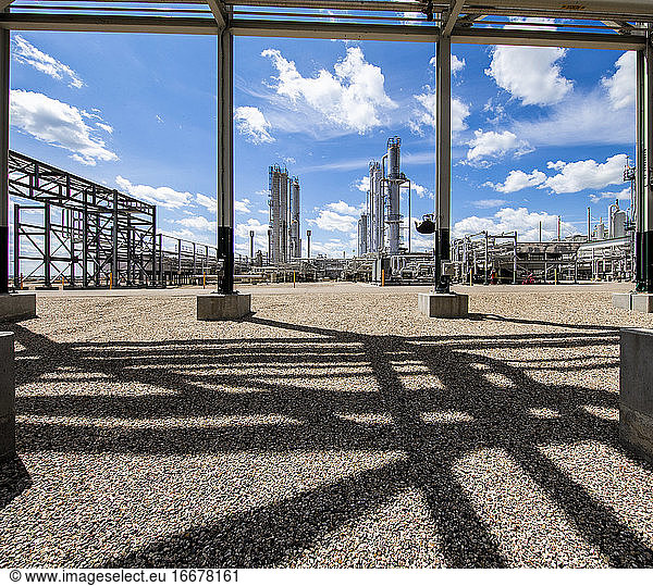 Natural gas plant structures against blue sky