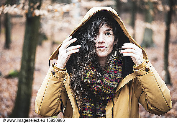 natural girl in winter jacket smiles in golden bronze autumn forrest